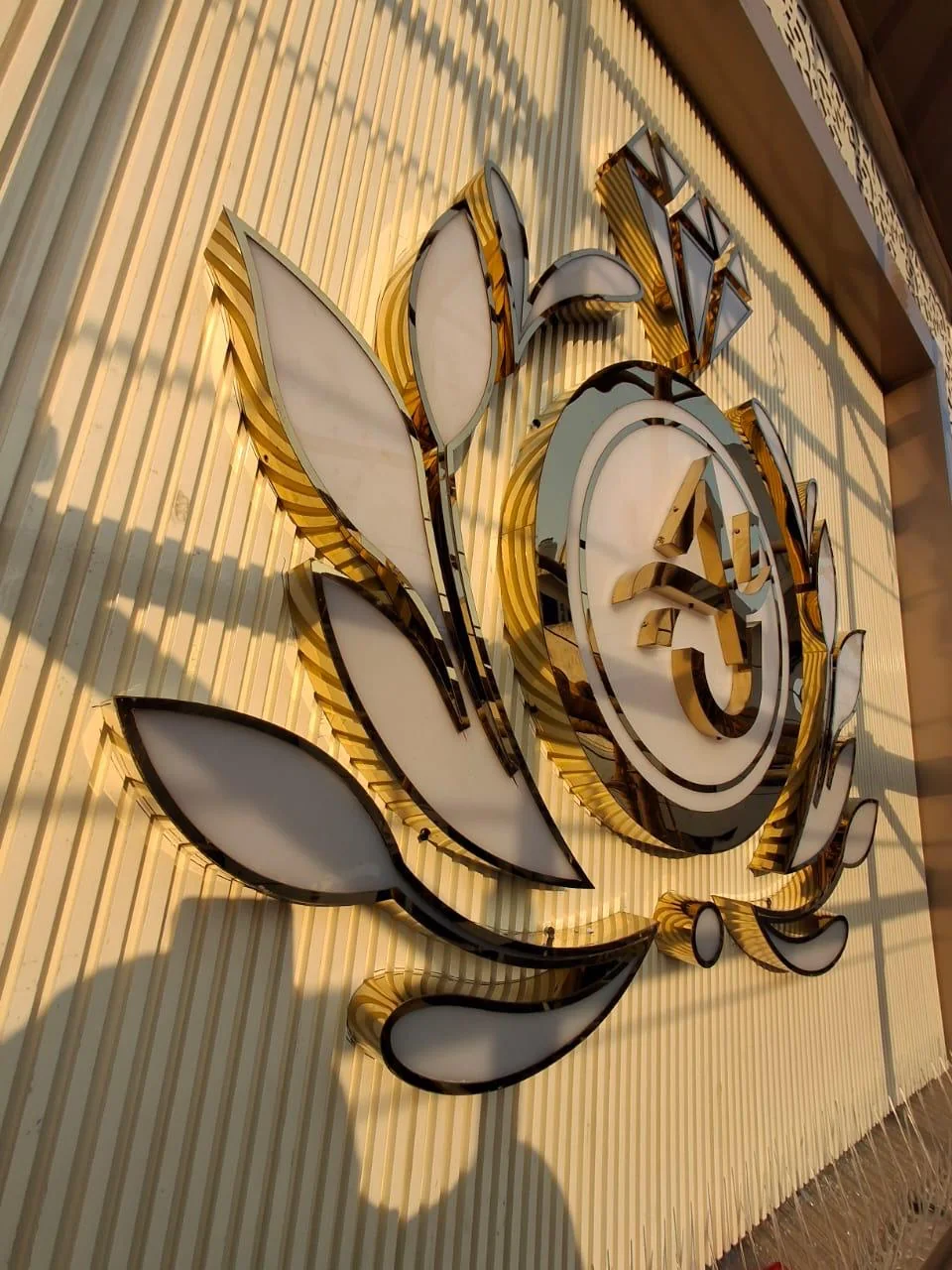 Gold acrylic emblem signage detail fabricated by Sonu Arts